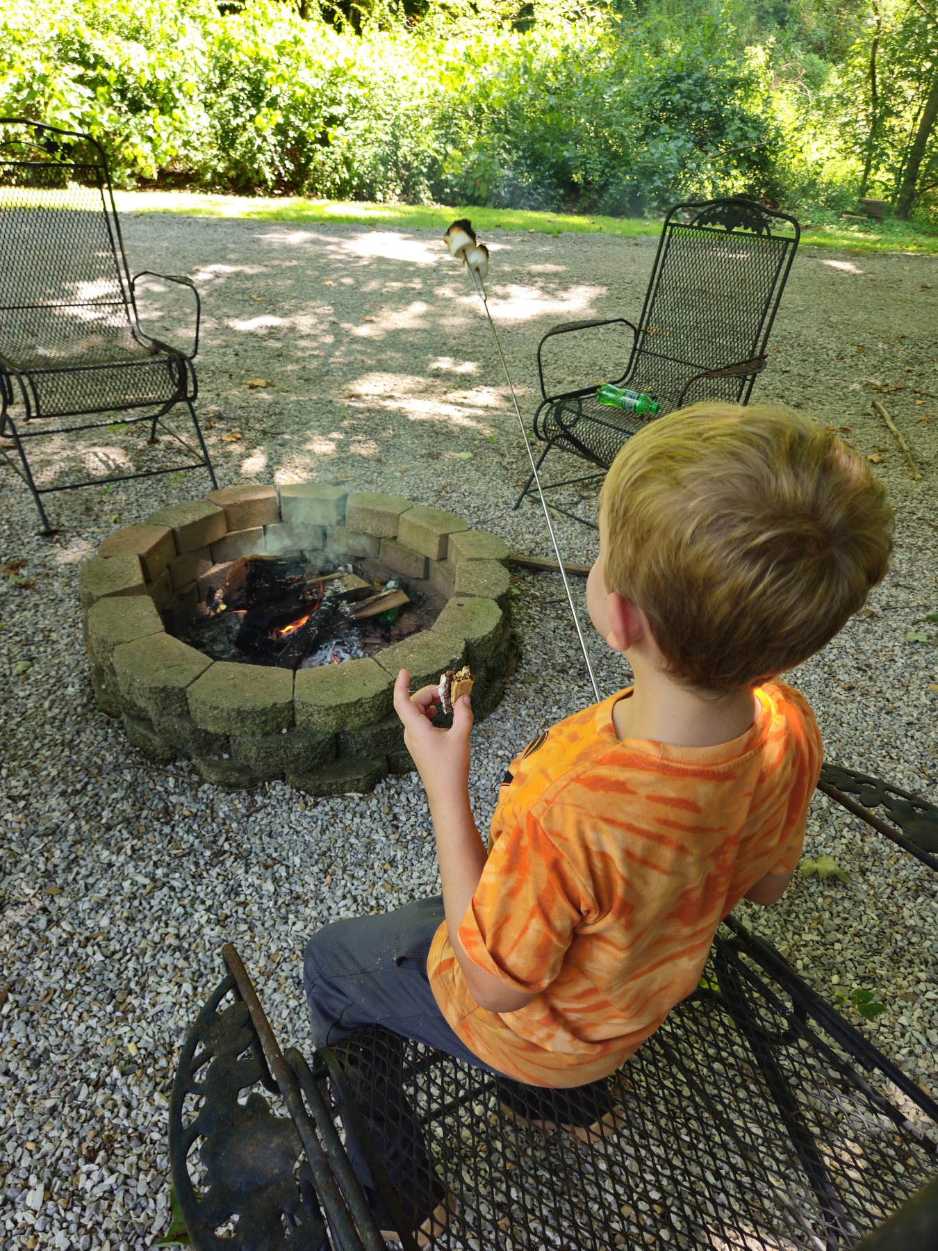 George roasting a marshmallow over the final fire of the week