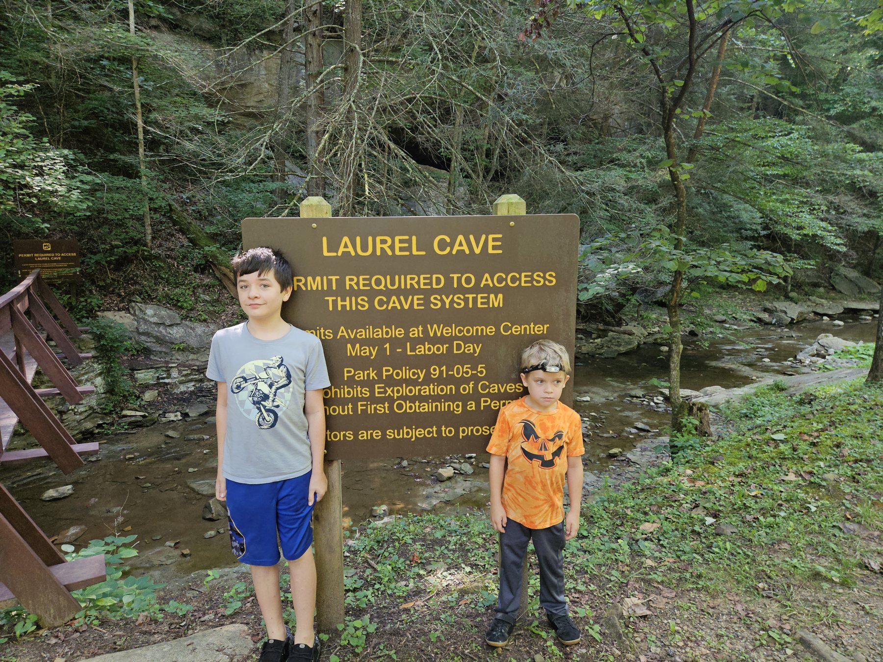 Mason and George standing at the Laurel Cave sign