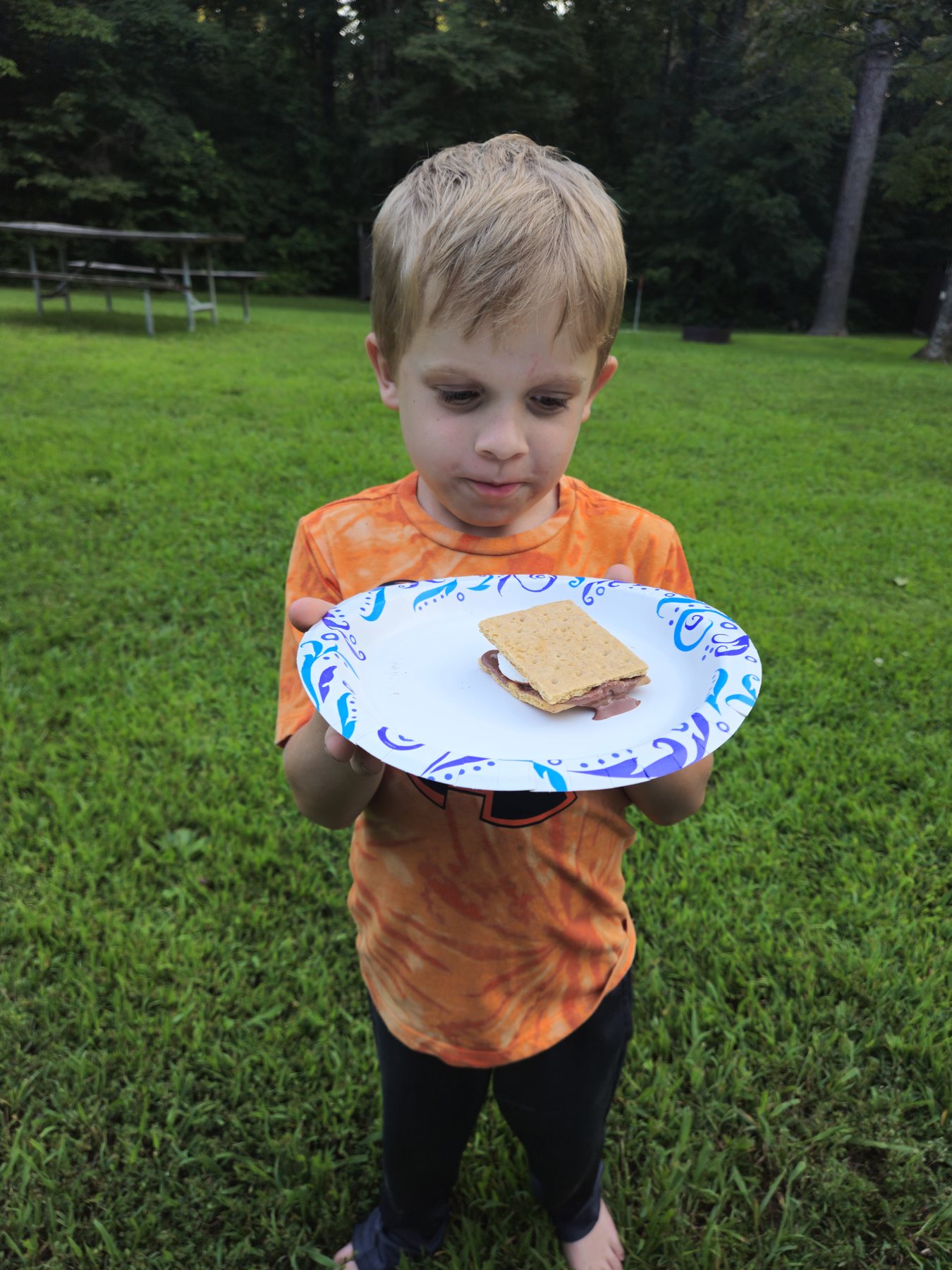 George holding up a grilled s’more