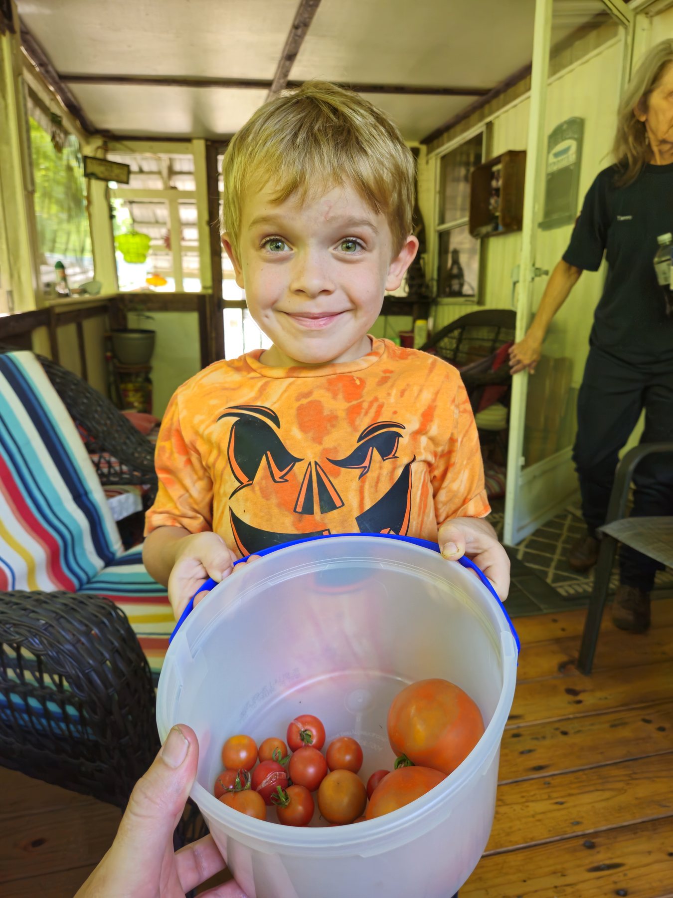George proudly holding a bucket of garden tomatoes